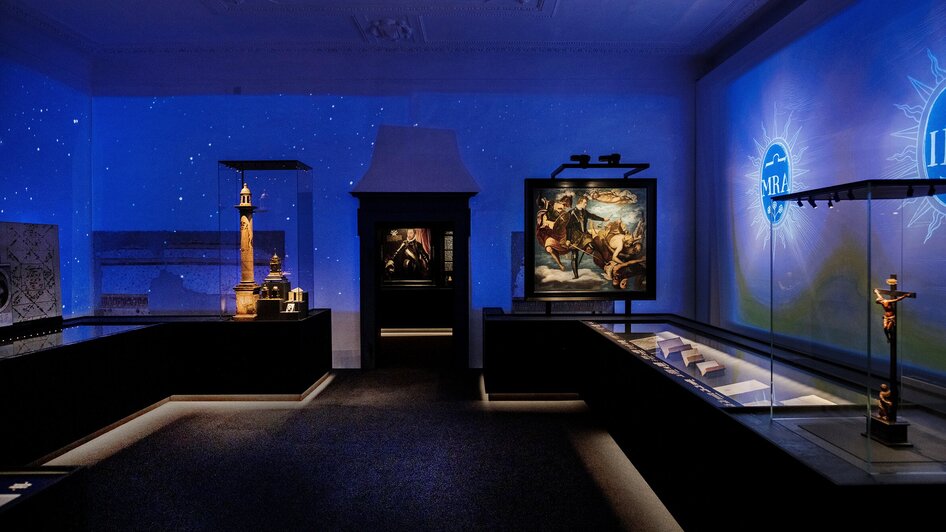 Eine Ausstellung mit stimmungsvoller Beleuchtung und Kunstwerken.